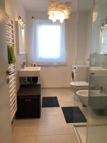 a bathroom with a sink and a toilet and a window at Dream Home - Kapuziner Platz in Brunico