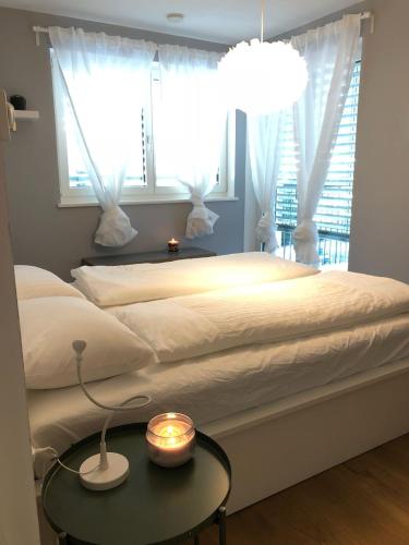a bedroom with a bed with a table and a window at Dream Home - Kapuziner Platz in Brunico