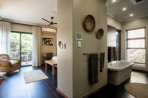 a bathroom with a bath tub and a sink at Buffalo Brooke in Hectorspruit