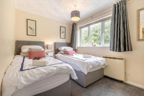 two beds in a room with a window at 2 Bed in Reedham oc-c29528 in Haddiscoe