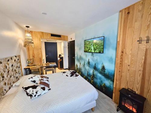 a bedroom with a bed with cow pillows on it at [Chalet] Studio Premium, WIFI, Chaleureux in Lourdes