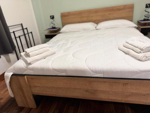 a bed with white sheets and towels on it at Dormire a Reggio zona Aeroporto in Reggio di Calabria
