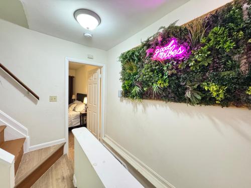 a hallway with a wall covered in plants at Downtown Private Rooms - Close to M&T, Orioles, Topgolf, Horseshoe Casino in Baltimore
