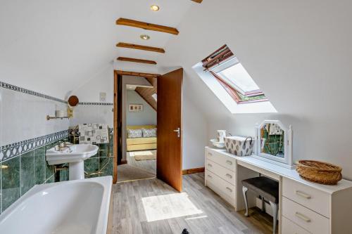 a bathroom with a tub and a sink and a mirror at 2 Bed in Aberystwyth oc-99869 in Devils Bridge