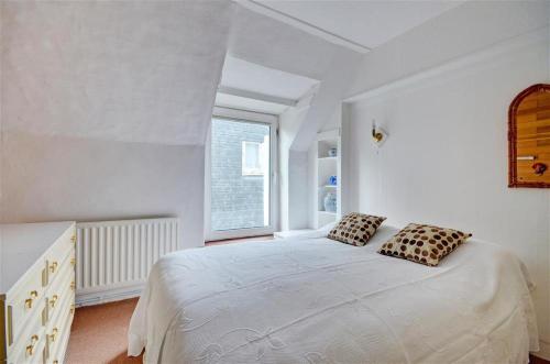 a white bedroom with a large bed and a window at 3 Bed in St Ives oc-pc1016 in St Ives