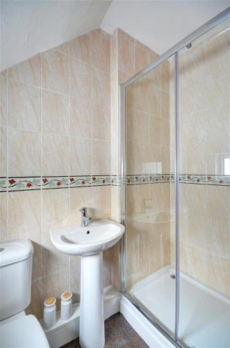 a bathroom with a toilet and a sink and a shower at 3 Bed in St Ives oc-pc1016 in St Ives