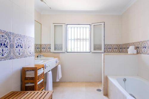 a bathroom with a tub and two sinks and a bath tub at Villa Acantilado Cabo de Palos in Cabo de Palos