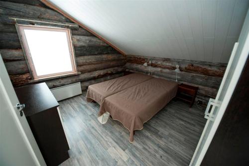 a bedroom with a bed and a window at Runoilevi B3 Visit Levi in Sirkka