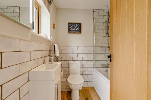 a white bathroom with a toilet and a sink at 2 Bed in Beer oc-s27769 in Beer