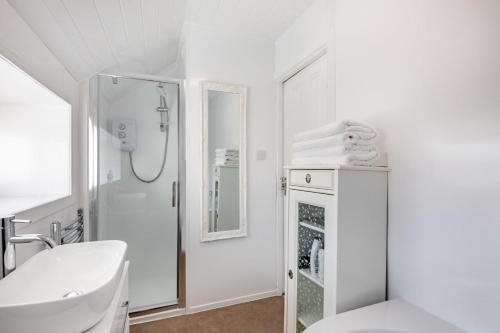 a white bathroom with a toilet and a shower at 2 Bed in Coldingham oc-c31971 in Coldingham