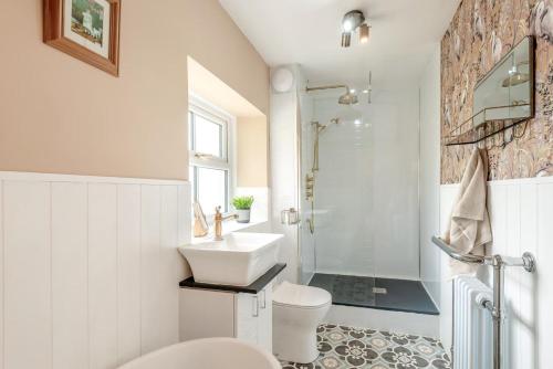 a bathroom with a sink and a toilet and a shower at 2 Bed in Staffield oc-j32453 in Kirkoswald