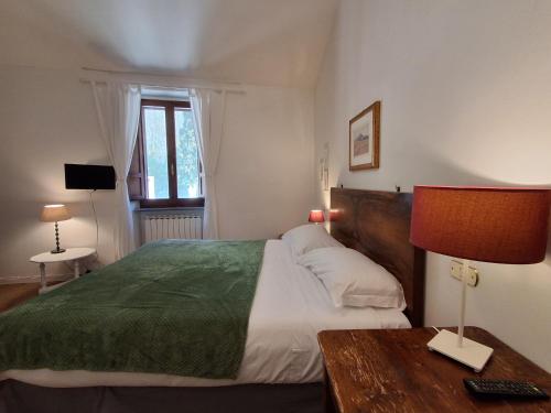 a bedroom with a bed and a table with a lamp at Civico 10 in Gubbio
