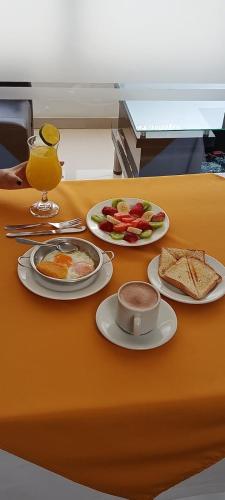 a table with two plates of food on it at Hotel Palermo Suite in Pasto