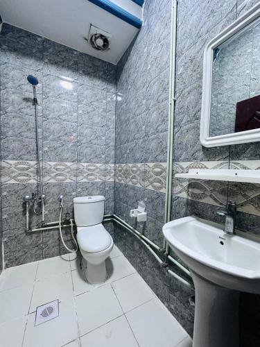 a bathroom with a toilet and a sink at Bab Al Bahrain Hotel in Manama