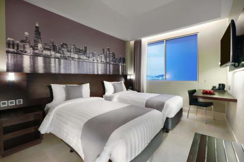 Postel nebo postele na pokoji v ubytování Hotel Neo+ Balikpapan by ASTON