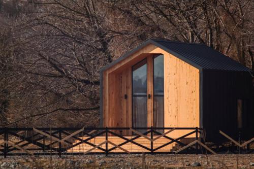 a small wooden cabin with a window in a field at Chateau Chapiteau in Gudzhareti