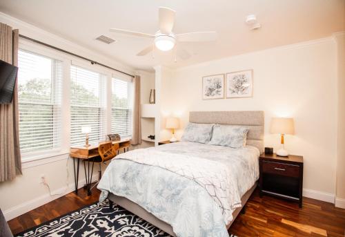 a bedroom with a bed and a desk and windows at 2 Bedroom Unit w Elevator & In-Unit Laundry in Boston