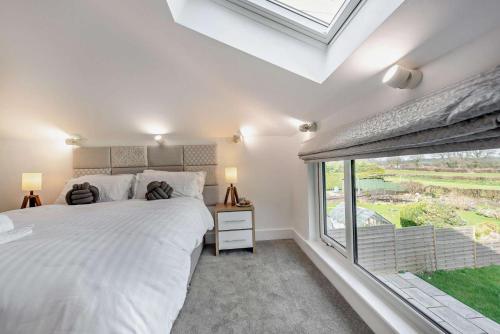 a bedroom with a bed and a large window at 2 Bed in Llanarthney oc-c28877 in Llanarthney
