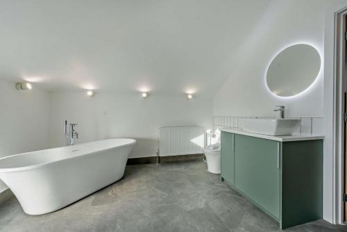 a bathroom with a tub and a sink and a toilet at 2 Bed in Llanarthney oc-c28877 in Llanarthney