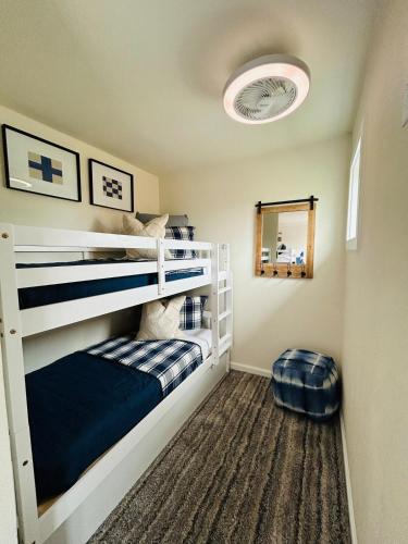 two bunk beds in a room with a mirror at LWV Dallas Social - Lakewood Village in Little Elm