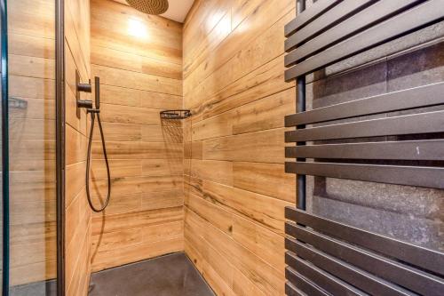 a bathroom with a shower with wooden walls at 3 Bed in Cromford oc-t30751 in Cromford