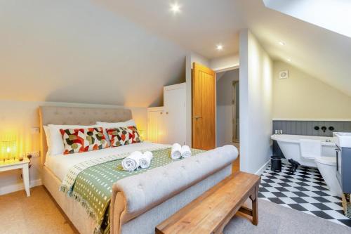 a bedroom with a bed and a tub and a sink at 3 Bed in Cromford oc-t30751 in Cromford