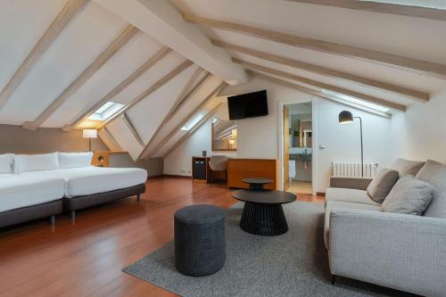 a living room with a couch and a table at Hotel de l'Isard in Andorra la Vella