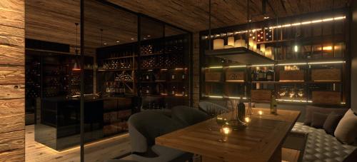 a restaurant with a wooden table and some wine bottles at SEVERIN*S – The Alpine Retreat in Lech am Arlberg