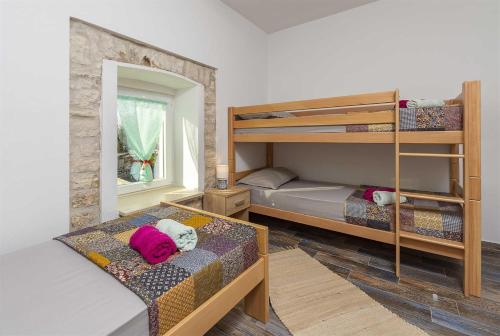 a room with two bunk beds and a mirror at Casa Mia By Kompas Villas in Butkovići
