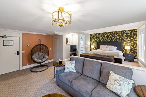 a living room with a couch and a bed at The White Inn in Fredonia