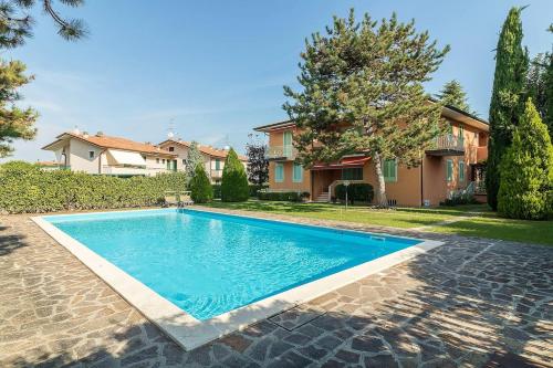 a swimming pool in the yard of a house at Appartamento Di Morgana Sirmione in Sirmione
