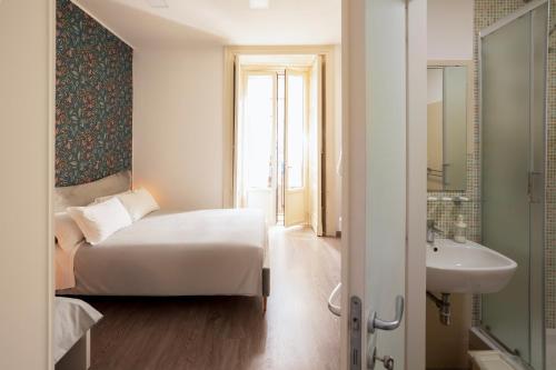 a hotel room with a bed and a sink at B&B Università in Catania