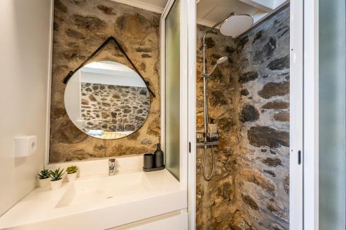 a bathroom with a sink and a mirror at Social Lodge Galinho House - Sea View - Calheta in Estreito da Calheta