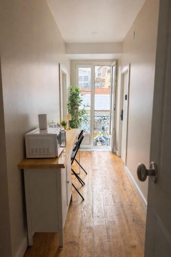 a kitchen with a counter with a microwave on it at Aurea Stay Lisbon-Quarto privado no centro in Lisbon