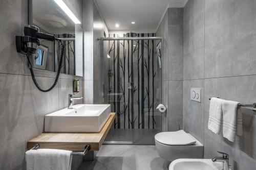 a bathroom with a sink and a toilet at Pier Hotel in Andalo