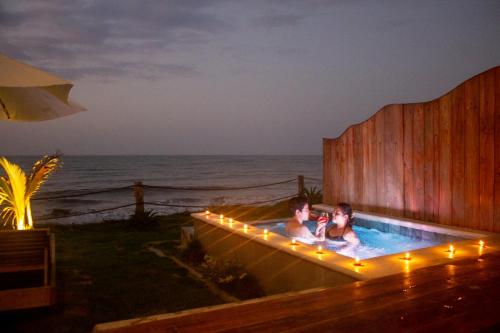 two people in a hot tub with lights at Primaluna Romantica in La Punta de los Remedios