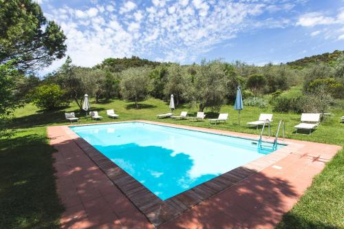 a pool with a pool table and chairs in it at Agriturismo Villa Buoninsegna in Rapolano Terme