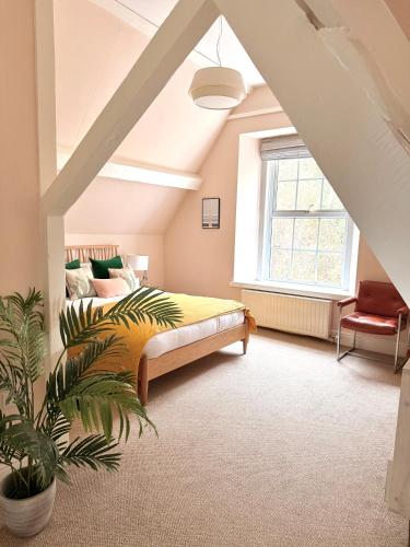a bedroom with a bed and a large window at Coed Mawr Hall Bed & Breakfast in Conwy