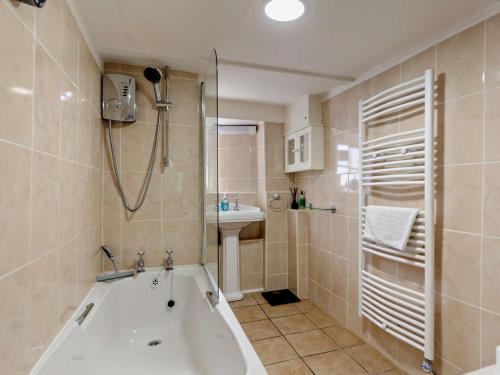 a bathroom with a tub and a sink and a shower at 2 Bed in Bridport oc-77557 in Loders