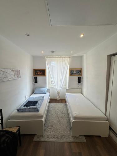 a bedroom with two beds and a window at Apartment LA DIMORA DEI PESCATORI in Muggia