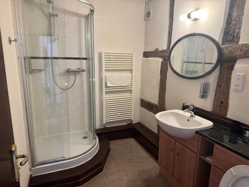 a bathroom with a shower and a sink at The Kings Arms in Cleobury Mortimer