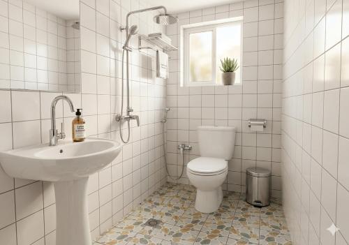 a white bathroom with a toilet and a sink at 2 chambres residence Dovv quartier Odja in Yaoundé