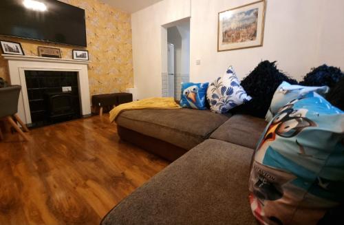 a living room with a couch and a fireplace at Seagulls Nest Holiday Cottage in Blackpool