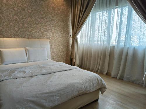 a bedroom with a bed and a large window at Sekinchan Paddy via Seaview Home 高楼 看海 稻田 民宿 in Sekinchan
