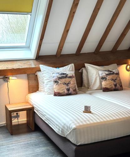 a bed in a room with a window at Hoevehotel 'Hof Christina' in Vrouwenpolder