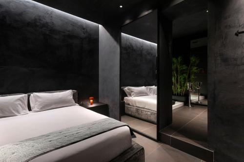 a bedroom with two beds and a mirror at B Suite Spa in Palermo