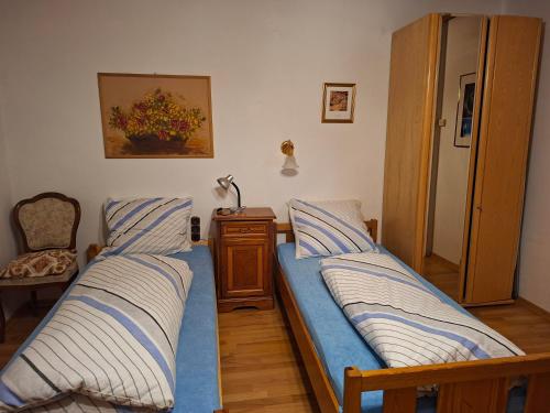 a bedroom with two beds and a table and a chair at Haus Rieder in Wörgl