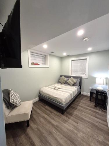 a bedroom with a bed and a tv in it at Compact,1BR Guesthouse Studio in Guelph