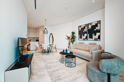a living room with a couch and a table at Stunning 1 Bed in Trilogy, Limassol Seafront in Limassol