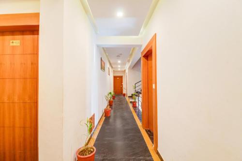 a hallway with potted plants on the walls at Palette by CheckIn Goverdhan Villas Formerly The White Fresco in Udaipur